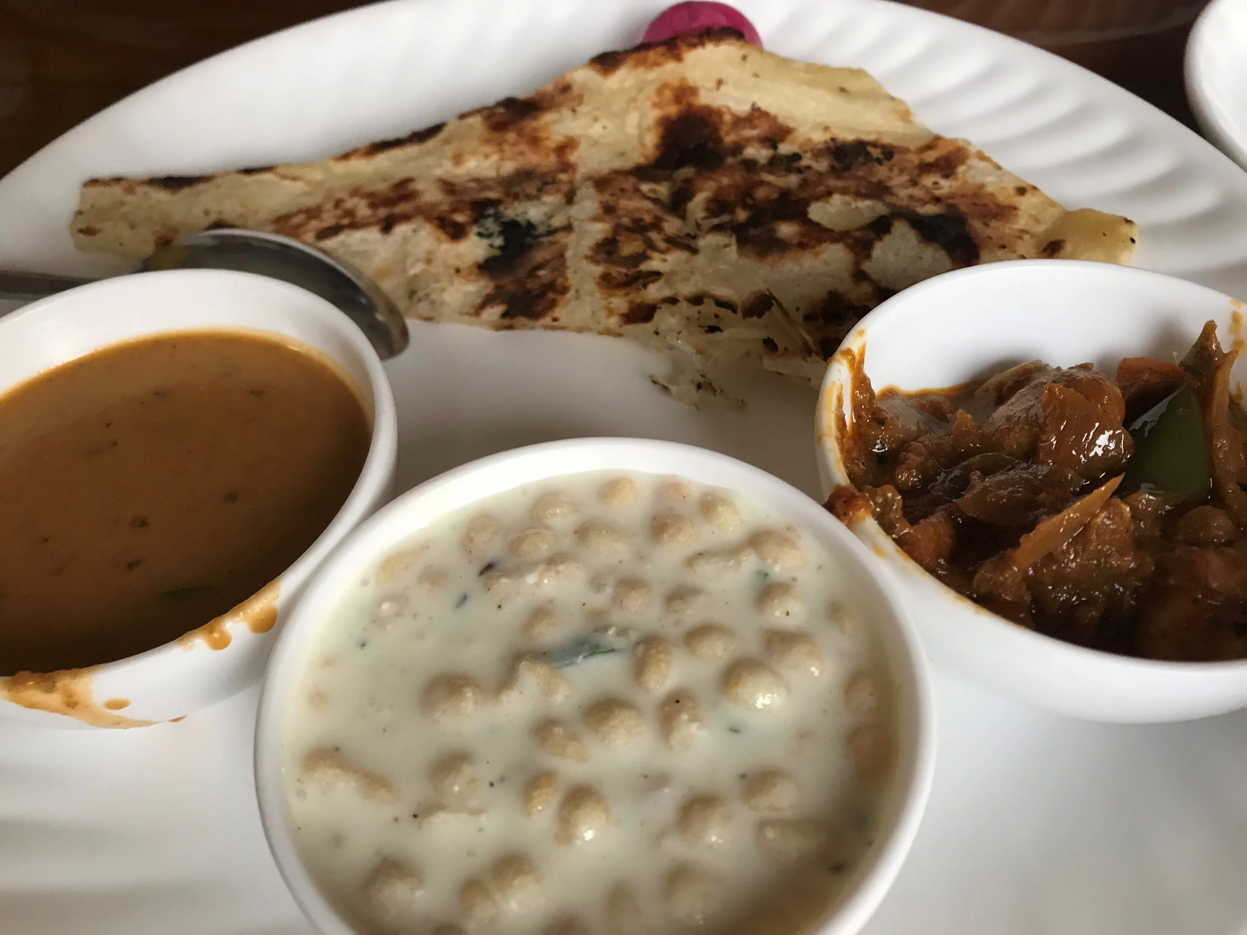 Authentic pure vegetarian royal Kumaoni thali with Bhatt ki Churkani, Dubke, tandoori roti, and Kumaoni raita